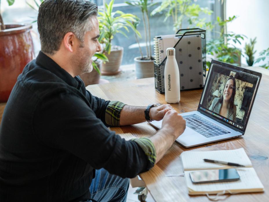 Man at a laptop on a video call with a colleague