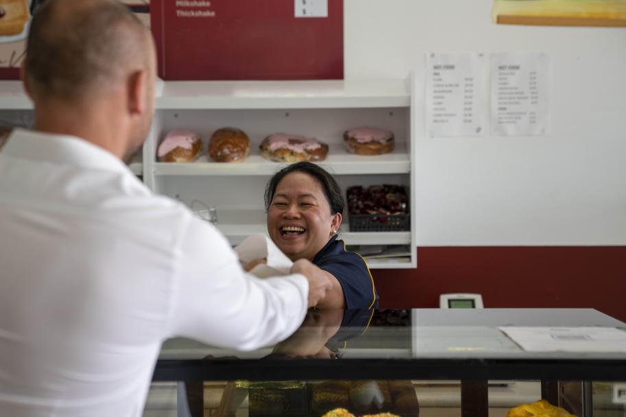 Female baker serving customer