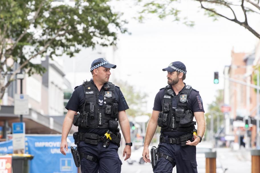 Two police officers walking on street